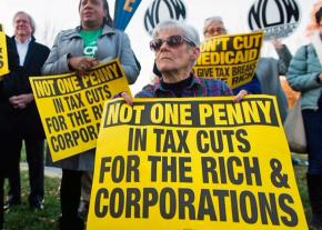 Protesters rally against the Republican tax bill outside the U.S. Capitol